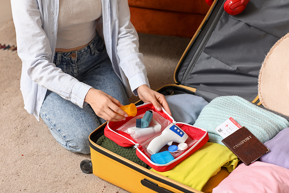 A woman packing her prescription medications for travel.