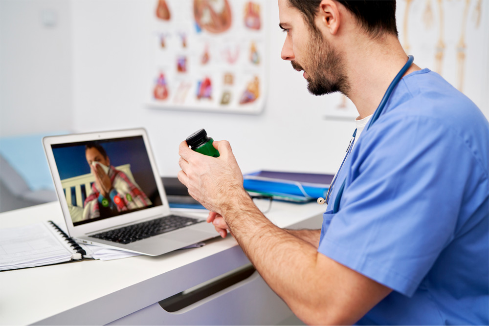 A telehealth provider consults a sick patient via a video call.