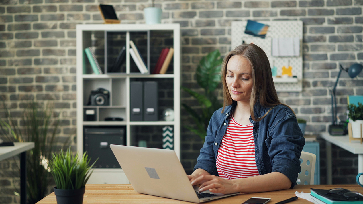 A woman browses an online pharmacy on her laptop.
