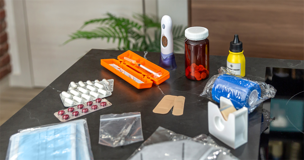 Various first aid kit items divided up for travel.