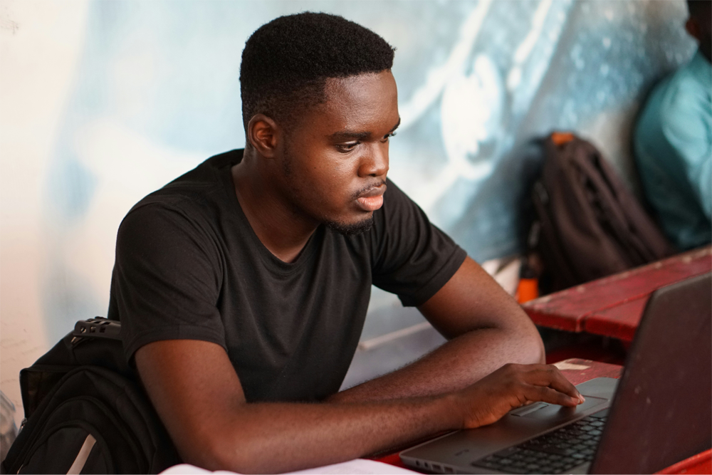 A college student tries to focus on writing his essay.