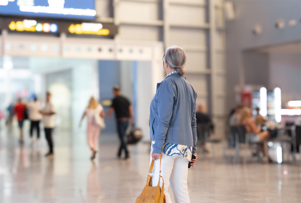 A woman stares at her surroundings inside an airport.