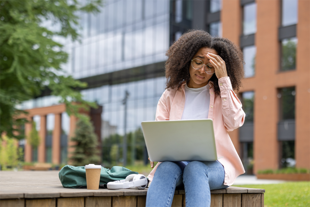 A college student is visibly stressed with their college schedule.