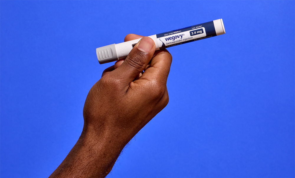 A patient holding a Wegovy® pen.