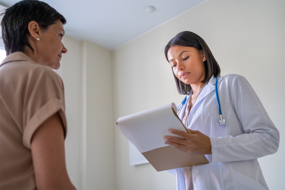 A provider discusses symptoms with a patient.