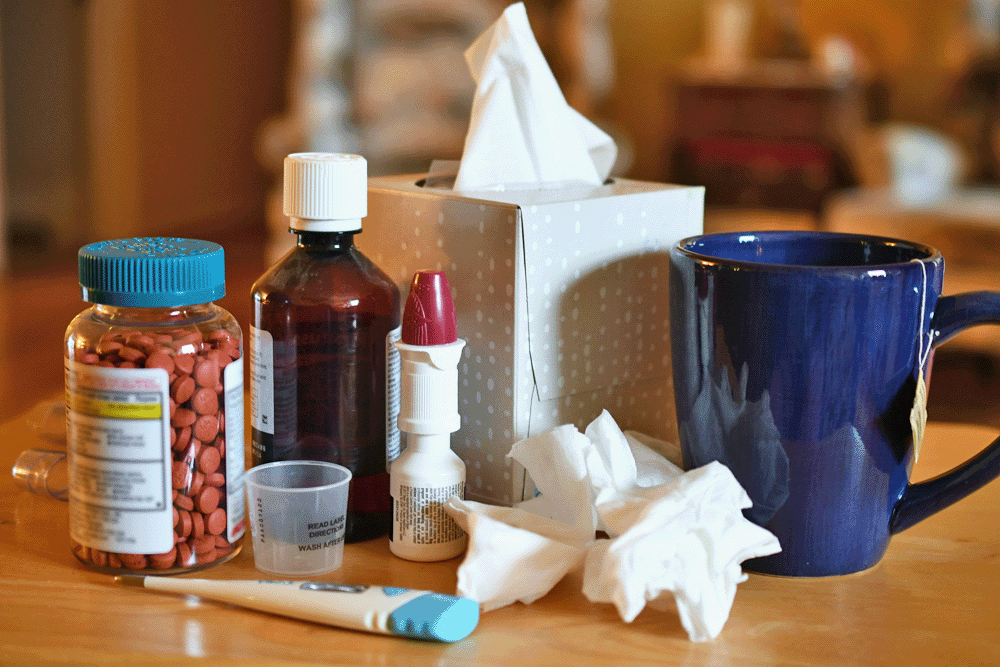 A box of tissues amongst various over the counter cold medications.