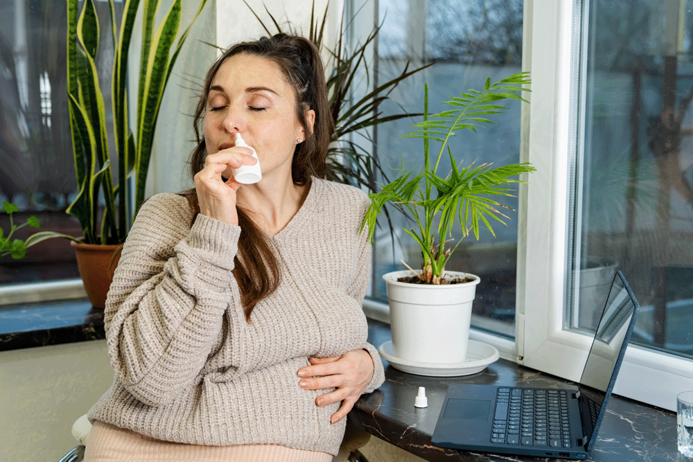 A woman using nasal spray for her allergies.