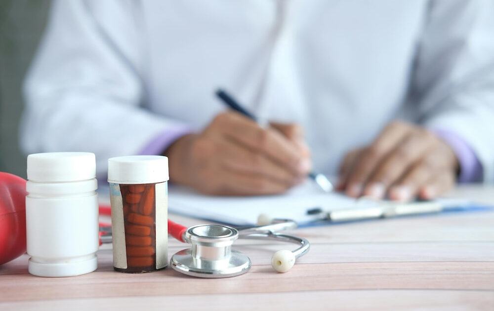 A doctor writing a prescription for a patient