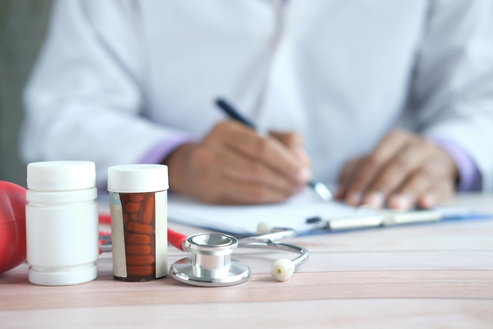 A doctor writing a prescription for a patient