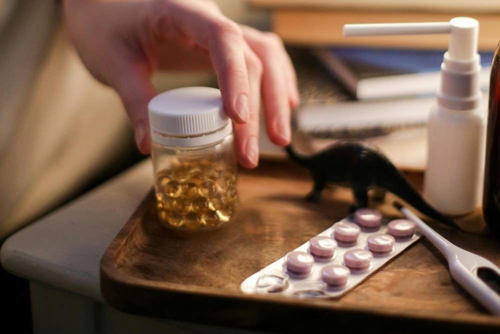 Woman reaching for a bottle of supplements to help with menopause symptoms.