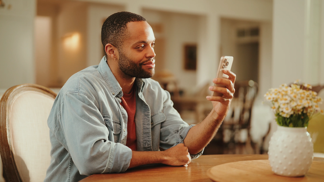 Man at a table reviewing a medication bottle