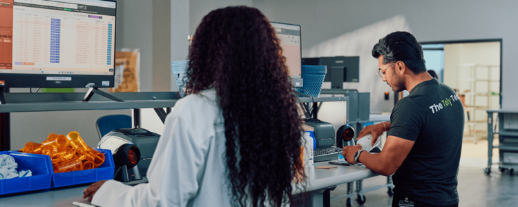 TelyRx pharmacy team reviewing prescriptions at workstations